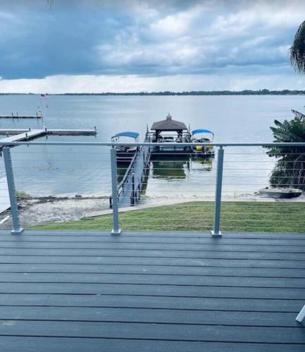 a dock with a boat in the water at Lakefront Duplex With Pontoon Boat 3 Bed House in Mount Dora