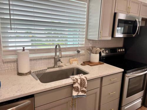 a kitchen counter with a sink and a window at Lakefront Duplex With Pontoon Boat 3 Bed House in Mount Dora
