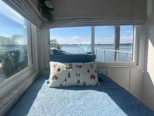 a bedroom with a bed with a large window at Lakefront Duplex With Pontoon Boat 3 Bed House in Mount Dora