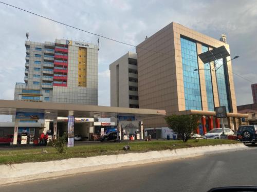 a gas station in front of some tall buildings at Hannatel Rooms Liberté in Douala