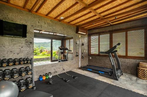 a room with a gym with a treadmill and a window at Samanvaya - Adults Only in Sidemen