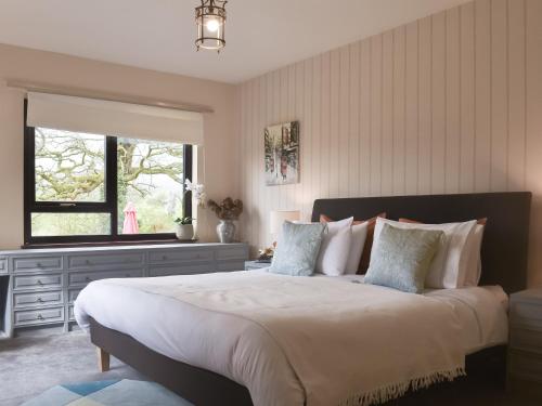 a bedroom with a large bed and a window at The Shieling in Padiham