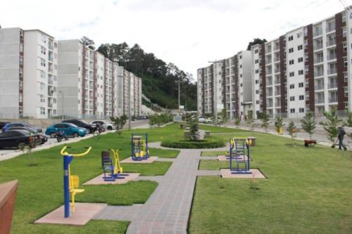 a park with playground equipment in the middle of a city at Cozy and relaxing apartment in Guatemala
