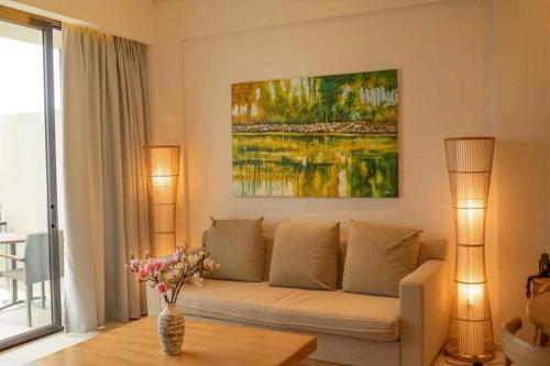 a living room with a couch and a painting on the wall at Villa seaview and apartment -Spa Da Nang Resort by JT group "Free pick up" in Da Nang