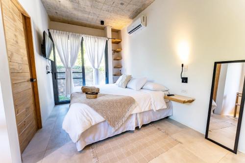 a bedroom with a bed and a large window at Alma Tropical - Luxury Villa Experience in Santa Teresa in Santa Teresa Beach