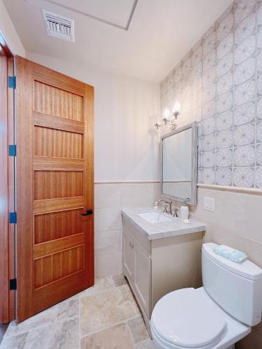 baño con aseo, lavabo y puerta en Casa Tranquila, en Willcox