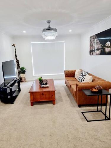 a living room with a couch and a tv at 5-Bedroom House: Ensuite, Netflix, Prime Location in Waterford