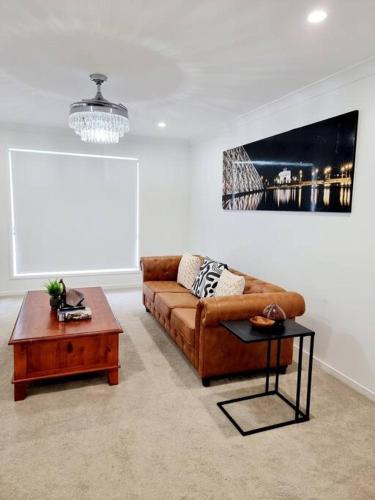 a living room with a couch and a coffee table at 5-Bedroom House: Ensuite, Netflix, Prime Location in Waterford