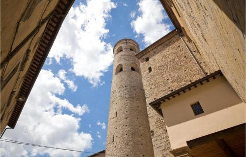a tall stone tower sitting next to a building at Amazing Apartment In Montefelcino in Montefelcino