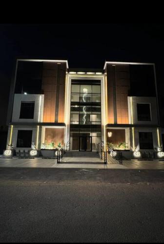 a building at night with a large window at The N&N Executive in Al Madinah