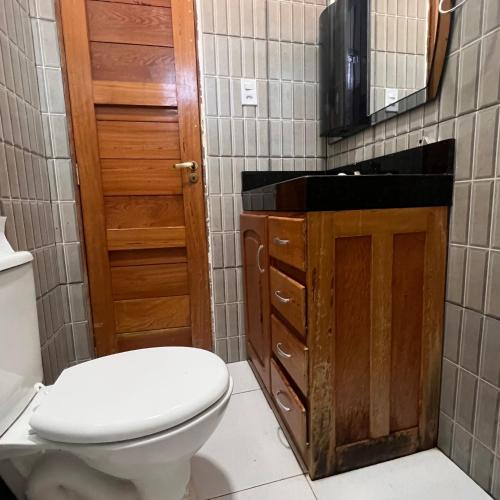 a bathroom with a toilet and a sink at Suíte completa em Parintins in Parintins