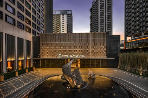 a fountain in the middle of a city with tall buildings at InterContinental Shenzhen WECC by IHG in Shenzhen