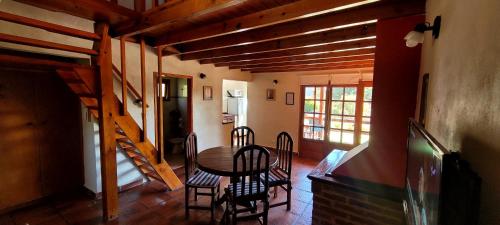 a dining room with a table and chairs at CasaAlpina in Tandil