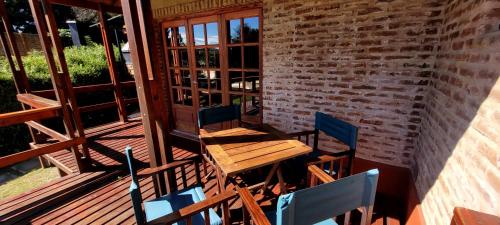a wooden table and chairs on a patio at CasaAlpina in Tandil