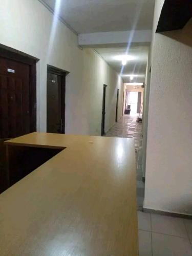 an empty room with a counter and a hallway at AMIGOS HOTEL in Ibadan