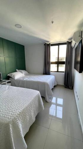 a hotel room with two beds and a window at Luxurious apartment located in the heart of Panama in Panama City