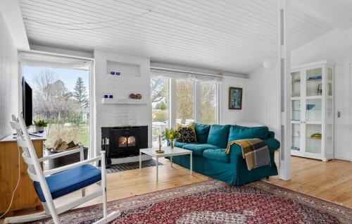 a living room with a blue couch and a fireplace at 3 Bedroom Gorgeous Home In Odder in Odder
