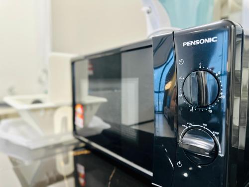 a toaster oven sitting on top of a counter at New 2BR or 3BR Homey Getaway stay 7 to 10 pax at Urban Suites, Georgetown by URBAN STAYCATION LOD in Jelutong