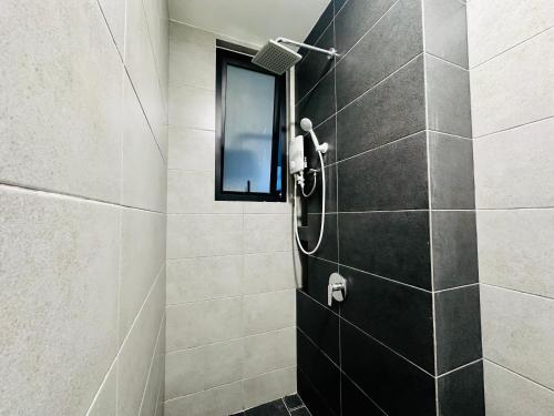a bathroom with a shower with a glass door at New 2BR or 3BR Homey Getaway stay 7 to 10 pax at Urban Suites, Georgetown by URBAN STAYCATION LOD in Jelutong