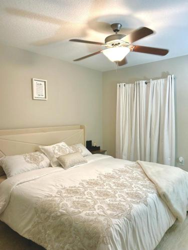 Coral gables apartment في ميامي: غرفة نوم مع سرير ومروحة سقف