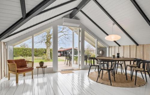 a dining room with a table and chairs at Cozy Home In Hejls With Wifi in Hejls