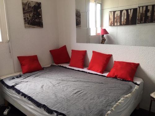 een kamer met een bed met rode kussens erop bij Chalet Gruissan, 4 pièces, 5 personnes - FR-1-784-20 in Gruissan