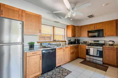 una cucina con mobili in legno e un frigorifero in acciaio inossidabile di Harmony Haven a Westmont