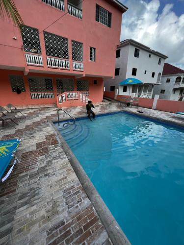a person standing in a swimming pool in front of a building at Hellshire Heights in Boscobel