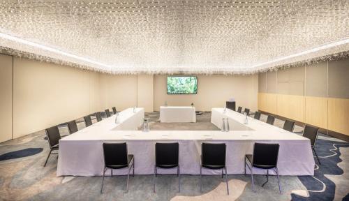 a conference room with a large white table and chairs at Grand Millennium Auckland in Auckland