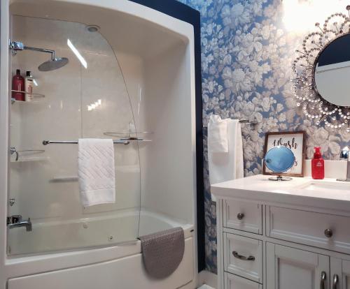a bathroom with a shower and a sink at EdgeWater Chemainus in Chemainus