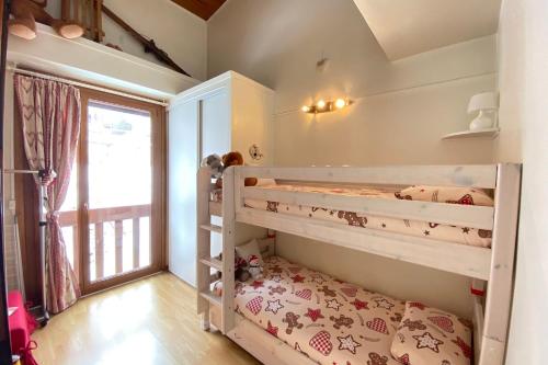 a childs bedroom with bunk beds and a window at 06BP - Beautiful 6-person apartment in Valberg in Valberg