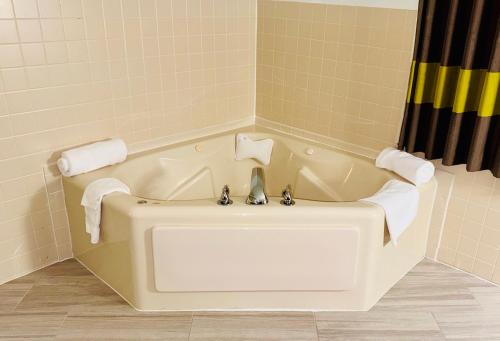 a bath tub in a bathroom with a shower at Forest City Inn in Forest City