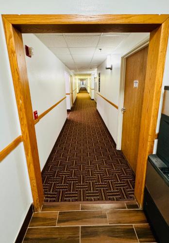 a hallway in an office building with a hallwayngth at Forest City Inn in Forest City