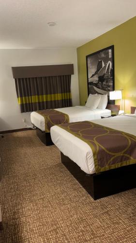 a hotel room with two beds in a room at Forest City Inn in Forest City