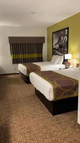 a hotel room with two beds in a room at Forest City Inn in Forest City