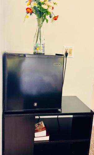 a vase of flowers sitting on top of a tv at Forest City Inn in Forest City