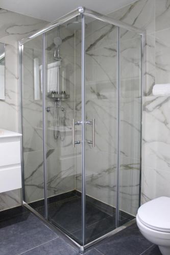 a glass shower in a bathroom with a toilet at Luxury Suite Apartment With Sea View #52 By Hashdera Eilat in Eilat