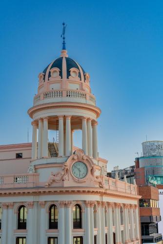 a building with a clock tower on top of it at Hostal Charlotte-Gran Vía in Madrid
