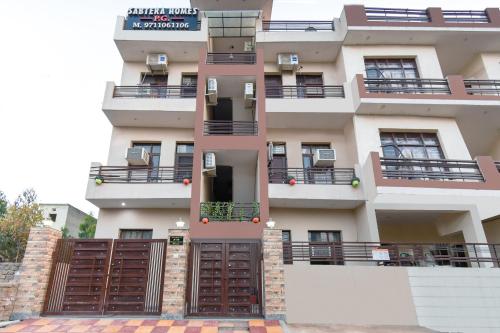 an apartment building with brown doors and balconies at OYO Sabtera Homes in Kharar