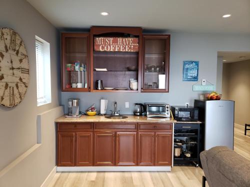 a kitchen with wooden cabinets and a white refrigerator at EdgeWater Chemainus in Chemainus