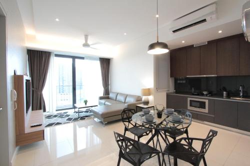 a kitchen and living room with a table and chairs at Grand Medini 3 mins drive Legoland in Nusajaya