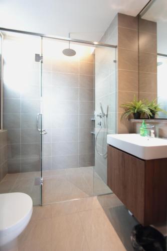 a bathroom with a shower and a toilet and a sink at Grand Medini 3 mins drive Legoland in Nusajaya