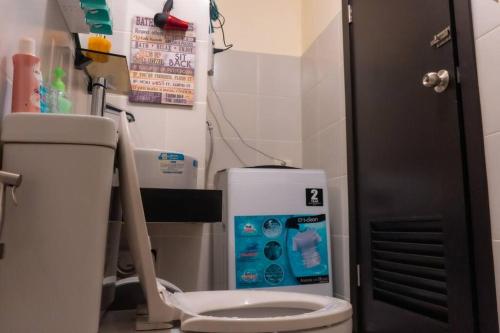 a bathroom with a toilet and a water heater at Luxury Resort Condo in Pasig FastWifiPoolSmartLock in Manila