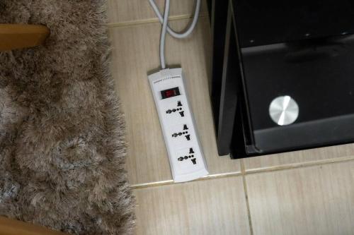 a remote control sitting on the floor next to a box at Luxury Resort Condo in Pasig FastWifiPoolSmartLock in Manila