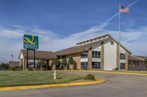 a building with an american flag in front of it at Quality Inn and Suites in Stuttgart