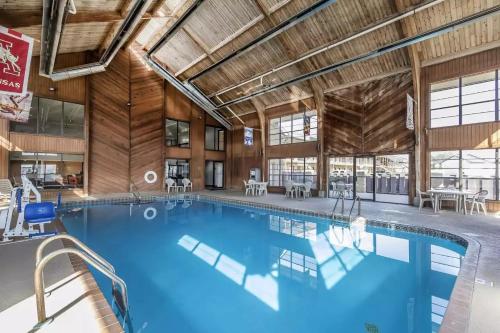 a large swimming pool in a large wooden building at Quality Inn and Suites in Stuttgart