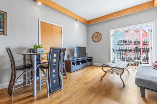 a living room with a table and a dining room at Charming Condo - European Vibe in Palm Coast