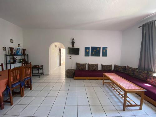 a living room with a couch and a table at Bahia Smir et Al Amin Plage Front mer in Fnidek