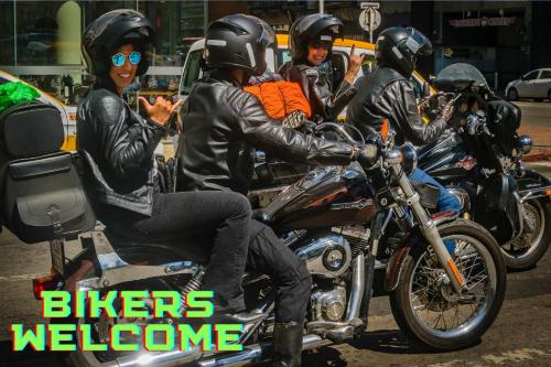 a group of people riding motorcycles down a street at Charming Condo - European Vibe in Palm Coast