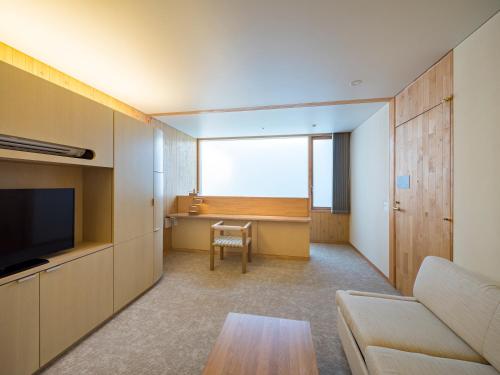 a living room with a couch and a table at Shonai Hotel Suiden Terrasse in Tsuruoka